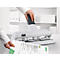 Person punching paper with a white Leitz punch.