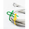 A gray cable, tied together with green and yellow cable ties, against a white background.