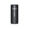 Enceinte Bluetooth cylindrique noire avec symbole plus et moins blanc. Fond neutre.