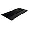 Schwarze Gaming-Tastatur mit integrierter Handballenauflage und dezent beleuchteten Tasten vor weißem Hintergrund.