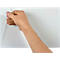 A hand is peeling a protective film off a white surface.