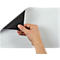 A hand lifting a corner of a white sheet, revealing a black underside.