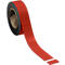 Roll of red tape with a piece detached.
