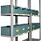 Shelving unit with green storage bins. Yellow labels with letter and number combinations are visible on the bins and shelving.