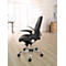 Black office chair with adjustable armrests and backrest. On light-colored floor in front of window and furniture.