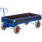 Blue transport cart with gray tires and red rims. Rectangular loading area with blue frame and brown side panels.
