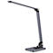A modern, gray desk lamp, standing on a rectangular base. The lamp head is flat and oblong.