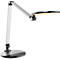 Bureau lamp met ronde lampkop en zilverzwart design. De lampkop is helder verlicht. De basis heeft aanraakbediening.