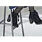 Close-up of black lace-up ankle boots with block heels. The wearer is sitting on a silver stool.