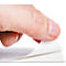 A hand peeling off a piece of white paper, in the foreground. The background is white.