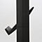 Close-up of a black, ribbed coat rack with protruding hooks.