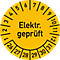 Gelber Aufkleber mit schwarzem Text "Elektr. geprüft". Zahlen markieren Monate von 1 bis 12 und Tage von 26 bis 31.