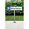 Parking sign with "P Employee" in front of a hedge.