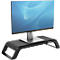 A Dell monitor sits on a black monitor stand.