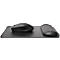 Black ergonomic mouse with wrist rest on a black mouse pad.