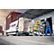 A worker pushes a yellow scaffold structure out of a van with a tailgate. Company logo and lettering on the vehicle.