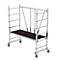 Scaffolding with wheels, silver metal frame and dark platform. The scaffolding is designed for working at height.