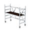 A rolling scaffold with a brown wooden platform and silver metal struts, against a white background.