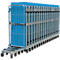Multiple blue roll cages side by side, metal frame, many wheels, ideal for transport.