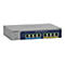 Commutateur rÃ©seau gris avec huit ports. Inscription : NETGEAR. Plusieurs LED et marquages colorÃ©s.