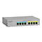 Commutateur rÃ©seau gris Netgear avec ports et LED, fond neutre.