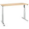 A height-adjustable desk. The table top is light, the legs silver.