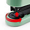Detail of a green stapler, marked with an arrow for movement.