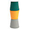 Three-legged, multi-colored stool. The seat is white, with dark green, orange and gray underneath.