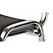 Close-up of a chair. The frame is shiny metal, the seat is gray-black, padded.