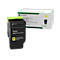 Black ink cartridge with yellow label and green cover. Packaging is also visible.