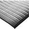 Black and gray ribbed mat with a rounded corner.