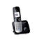Schwarzes Panasonic DECT-Schnurlostelefon mit beleuchtetem Display und silberner Tastatur in der Basisstation.