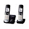 Zwei silber-schwarze Panasonic DECT-Telefone mit Basisstation auf weißem Hintergrund.
