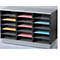 A gray and black filing system with open compartments containing colored sheets.