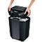 Hands lifting the black paper shredder top. Filled paper shreds underneath. The word Fellowes is visible on the device.