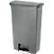 Grey trash can with lid, step function and logo. The lid is slightly rounded. At the bottom is the foot pedal.