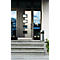 Grey front door with rectangular windows, in front of grey stone steps. Next to it, a silver trash can and flower boxes.