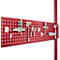 Red pegboard with tools, such as pliers, hooks and screwdrivers.