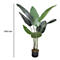 Grande plante artificielle dans un pot noir. Ligne de mesure : 1150 mm. Les feuilles sont vertes et allongées.