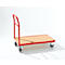 A red transport trolley with a wooden top and four wheels, in front of a white background.