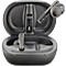 Dark gray earbuds in an open charging case. One earbud sits in the case, one is next to it.