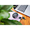 Black mobile Wi-Fi router, wireless earbuds, and laptop on a wooden desk. Symbols on screen.