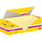 Bloc-notes Post-it jaunes dans une boîte ouverte. Les mots 'Post-it' et 'super sticky' sont visibles.