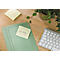 Bureau avec un post-it indiquant "Important!", un dossier, un clavier et une plante.