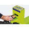 Close-up of a person inserting batteries into a yellow-green scale. "PK22" is visible on the display.