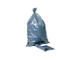 Gray garbage bag tied in a knot, next to it a roll and a sheet of garbage bags.