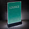 Illuminated sign with “LOUNGE” text, on a black base against a gray background.
