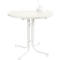 White, round high table with bottle and glass. Table leg with base.