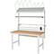 Werkbank mit Regalen und Papierspendern, weißes Gestell, Holzplatte.