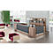 Modern reception desk with wood and grey tones, shelves behind and comfortable seating.